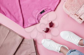 Flat Lay Shot Of Female Pastel Pink Clothing With Feet