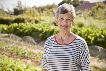 Portrait Of Mature Woman Standing On Allotment
