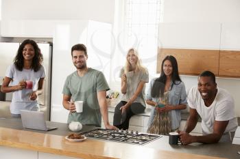 Portrait Of Friends Meeting For Coffee In Modern Kitchen