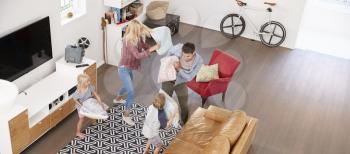 Overhead Shot Of Parents Playing With Children In Lounge