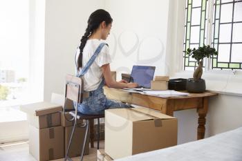 Rear View Of Woman Running Business From Home Dispatching Goods