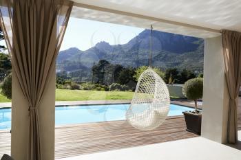 Suspended Seat Next To Decking Around Outdoor Swimming Pool