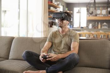 Man Playing Computer Game Wearing Virtual Reality Headset