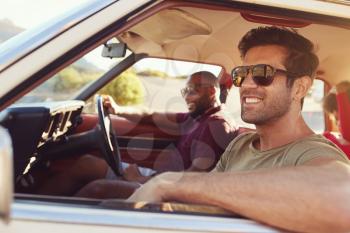 Two Male Friends Relaxing In Car During Road Trip
