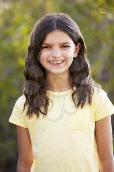 Portrait of a smiling girl looking to camera outdoors