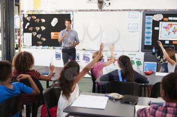Teacher addressing pupils in an elementary school lesson