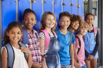 School kids in front of lockers in elementary school hallway