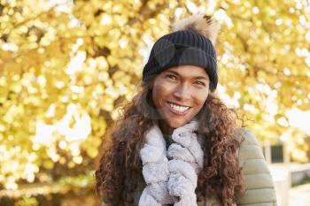 Outdoor Portrait Of Smiling Woman Wearing Scarf In Autumn