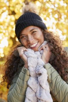 Outdoor Portrait Of Smiling Woman Wearing Scarf In Autumn
