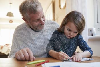 Grandfather And Granddaughter Colouring Picture Together