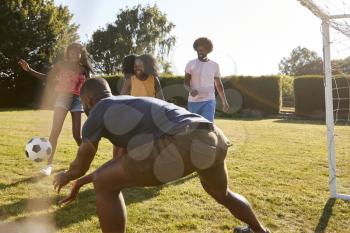 Four black adult friends having a fun game of football