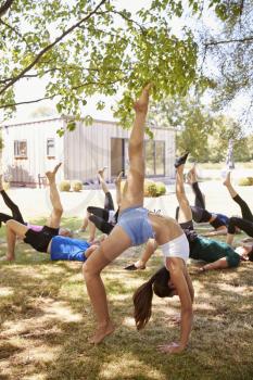 Female Instructor Leading Outdoor Yoga Class