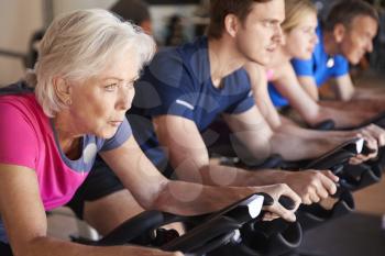 Close Up Of Group Taking Spin Class In Gym