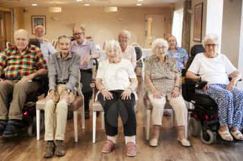 Portrait Of Senior Residents Of Retirement Home Sitting In Lounge