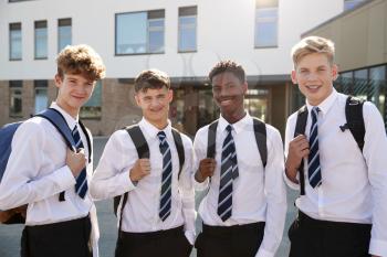 Portrait Of Smiling Male High School Students Wearing Uniform Outside College Building