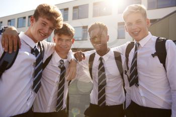Portrait Of Smiling Male High School Students Wearing Uniform Outside College Building