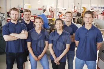 Apprentice engineers in their workplace, group portrait