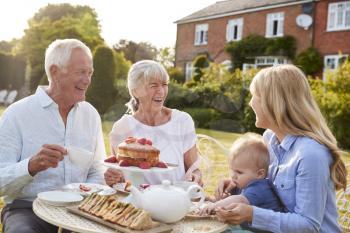 Grandparents Have Afternoon Tea With Grandson And Adult Daughter
