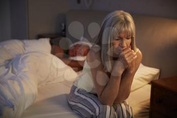 Worried Senior Woman In Bed At Night Suffering With Insomnia