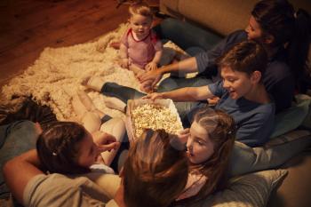 Overhead View Of Family Enjoying Movie Night At Home Together