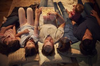Overhead View Of Family Enjoying Movie Night At Home Together