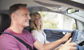 Mature Couple Sitting In Car On Road Trip