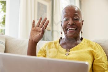 Senior Woman Using Laptop To Connect With Family For Video Call
