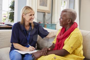 Female Support Worker Visits Senior Woman At Home