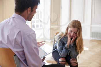 School Counselor Talking To Depressed Female Pupil