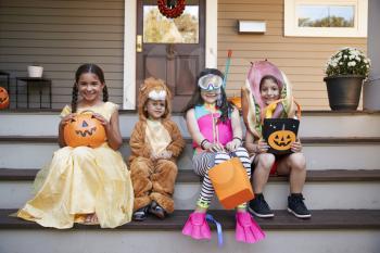 Children Wearing Halloween Costumes For Trick Or Treating