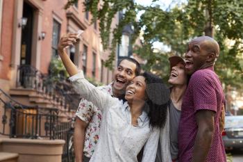 Group Of Friends Posing For Selfie On Street In New York City