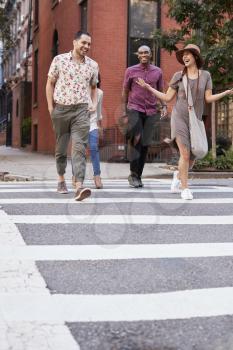 Group Of Friends Crossing Urban Street In New York City
