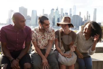 Friends Visiting New York With Manhattan Skyline In Background