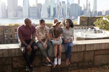 Friends Visiting New York With Manhattan Skyline In Background