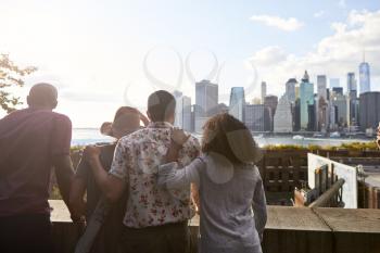 Rear View Of Tourists Looking At Manhattan Skyline