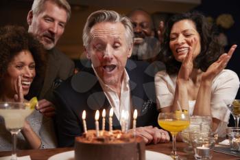 Group Of Middle Aged Friends Celebrating Birthday In Bar