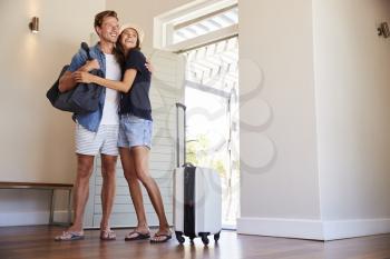 Couple Arriving At Summer Vacation Rental