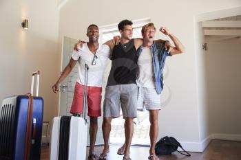 Group Of Male Friends Arriving At Summer Vacation Rental