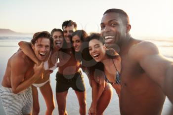 Group Of Friends Posing For Selfie Together On Beach Vacation
