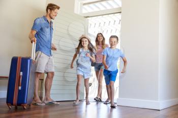 Family Arriving At Summer Vacation Rental