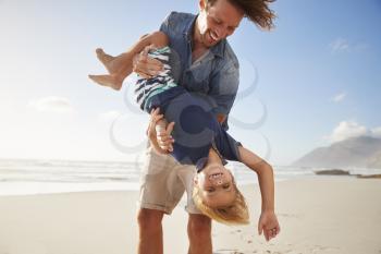 Father Having Fun With Son On Summer Beach Vacation