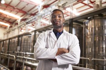 Portrait of a young black male technician at a wine factory