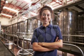 Portrait of young mixed race woman working at a wine factory
