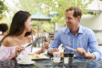 Portrait Of Couple Enjoying Meal At Outdoor Caf Together