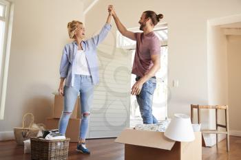 Couple Celebrating In New Home On Moving Day