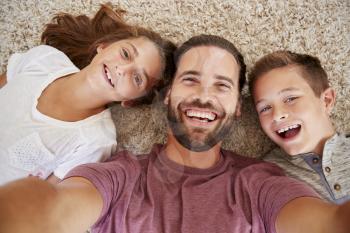 Point Of View Shot Of Father And Children Posing For Selfie