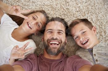 Point Of View Shot Of Father And Children Posing For Selfie