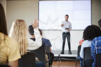 Pupil Asking Question During Presentation By High School Teacher