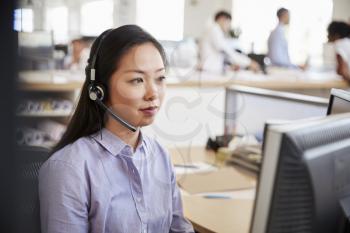Young Asian woman working in a call centre