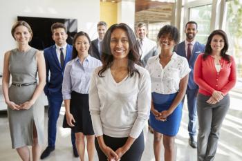 Mixed race businesswoman and business team, group portrait